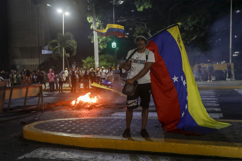 Gas, gunfire, and water cannons: Protests against Maduro erupt in Venezuela