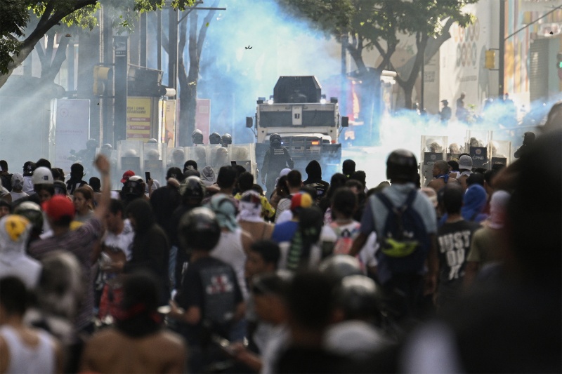 Gas, gunfire, and water cannons: Protests against Maduro erupt in Venezuela
