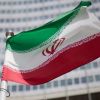 Iran protests gain momentum as state flag torn down in Mashhad