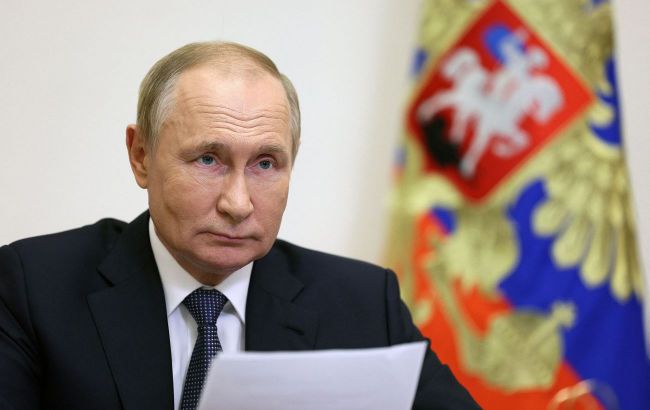 Putin says Russia will cut military spending as economy 'on the brink of going into a recession'