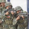 Philippines responds to China by landing and raising flag on disputed islands
