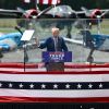 Trump holds first rally after assassination attempt behind bulletproof glass