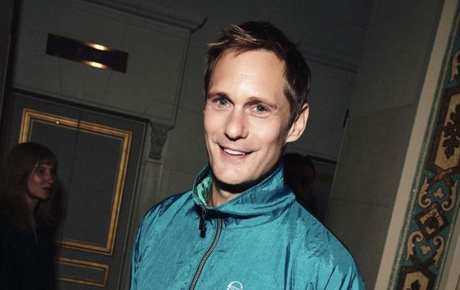 Alexander Skarsg&aring;rd stuns in a gold suit and sheer Saint Laurent shoes