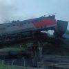 Train plunges off bridge onto highway near Kursk, sparking fire and injuries