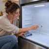 Why water collects under fridge drawers and how to safely clear drainage hole